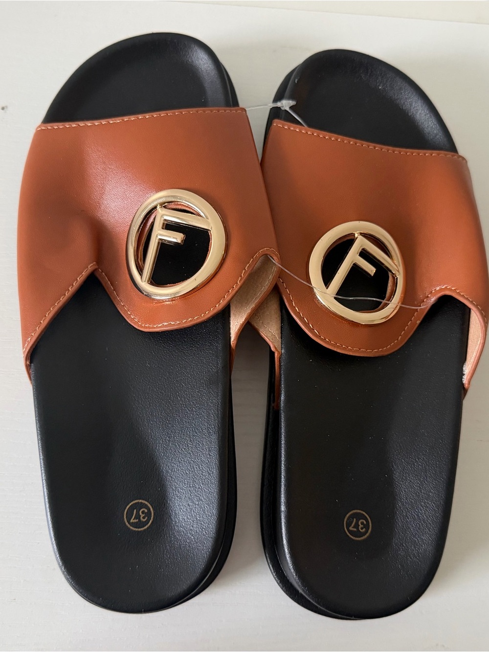 No Boundaries Tan Slide Sandals with Gold Emblem